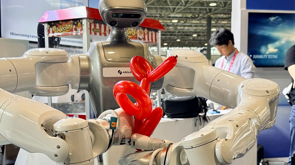 AGILINK multi-arm humanoid holding a red balloon dog sculpture at ICRA 2026