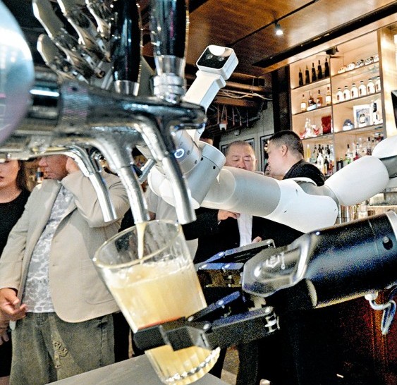 Close-up of AlphaBot 2 gripper holding a glass under beer taps