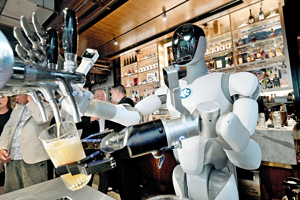 White wheeled AlphaBot 2 pouring beer from a tap into a glass at a Lan Kwai Fong bar