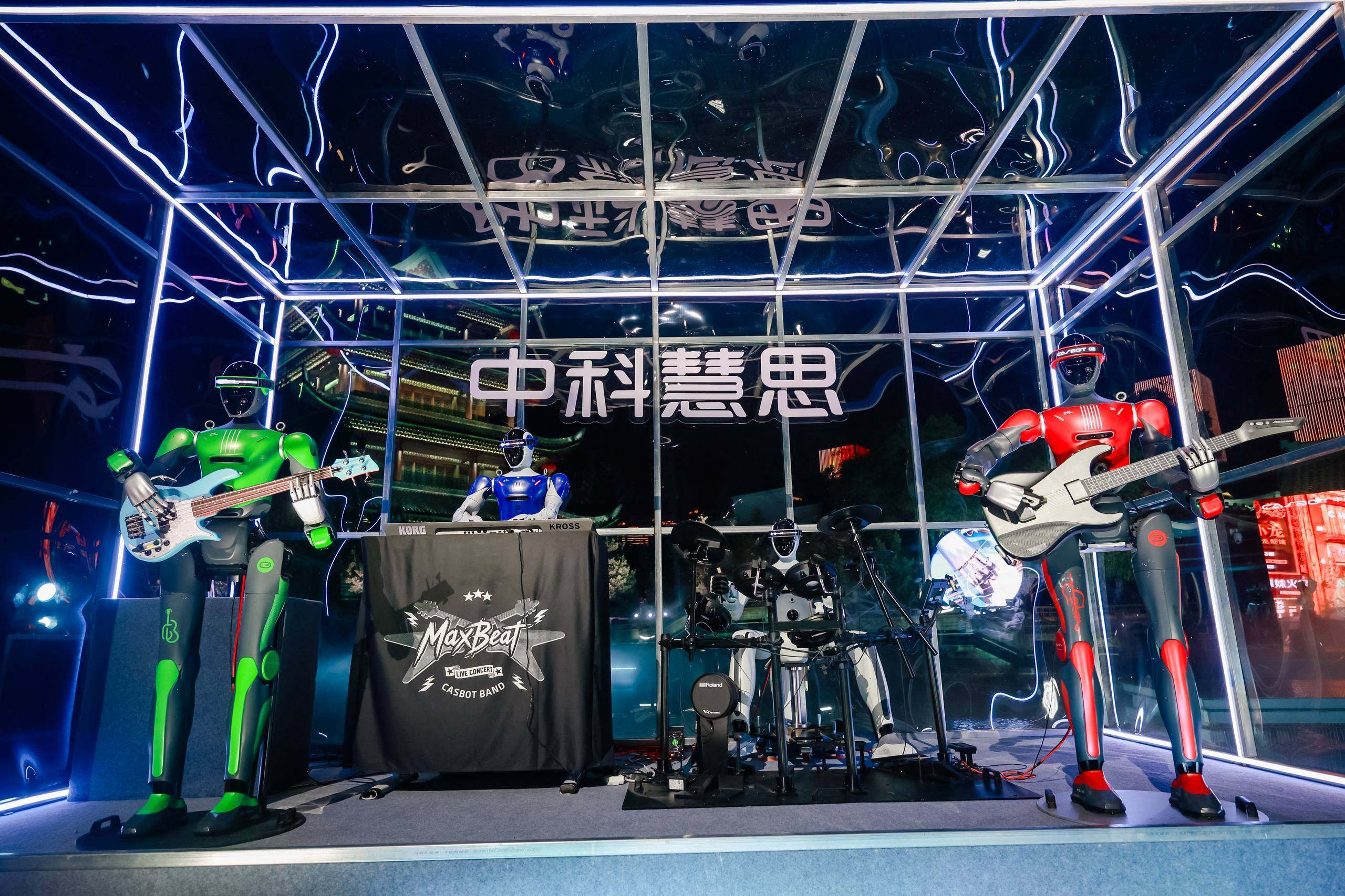 Four CASBOT humanoid robots playing bass, keyboard, drums, and guitar as CASBOT BAND