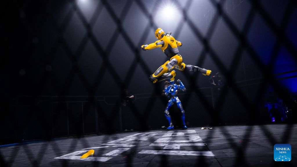 Yellow T800 airborne over a blue T800 inside the Riyadh cage