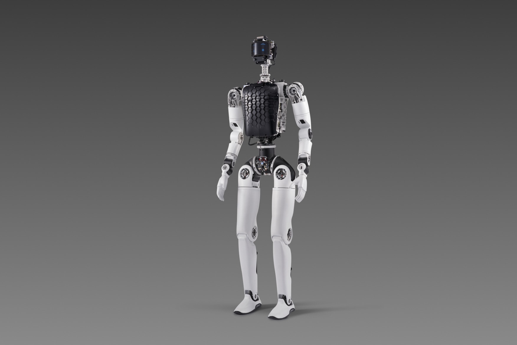 Full-size white Faraday Future Futurist humanoid standing on a gray studio background