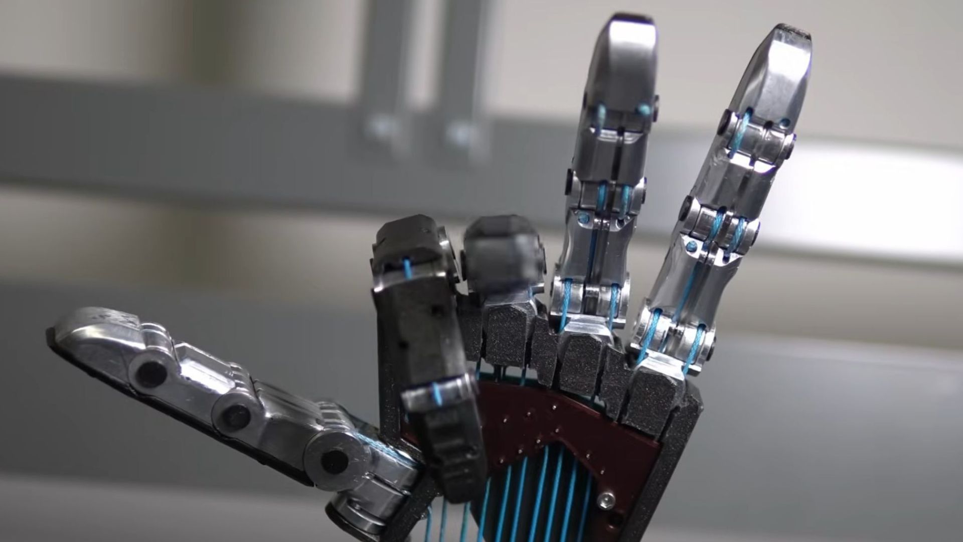 Close-up of Foundation tendon-driven robotic hand with blue tendons