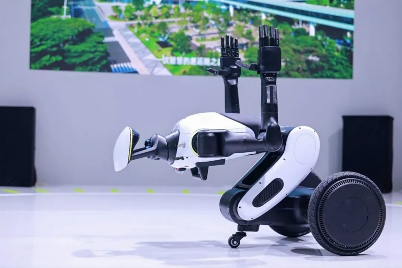 GoMate Mini folded into a low transport pose with arms raised and a large wheel visible