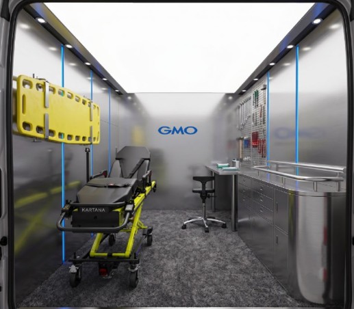 Interior of the GMO van with a stretcher, workbench, and tool wall