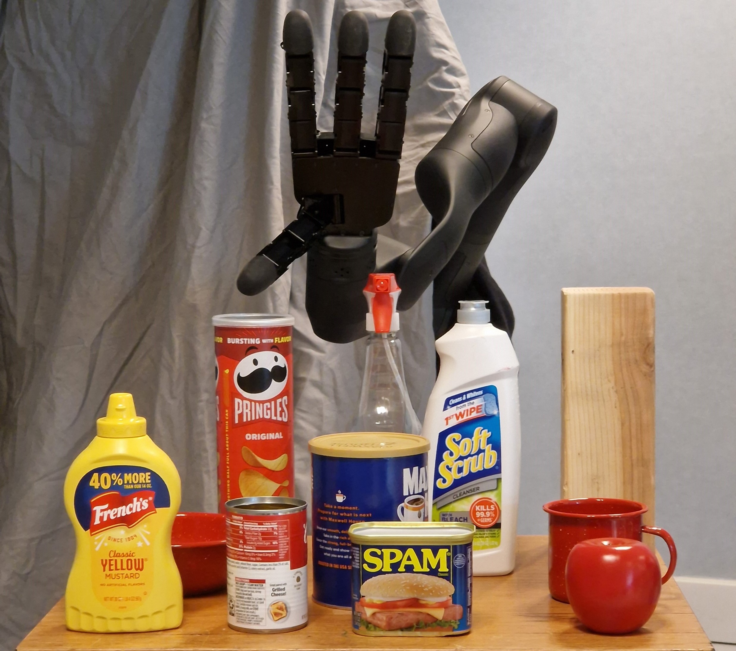 Allegro hand above a table of YCB household objects