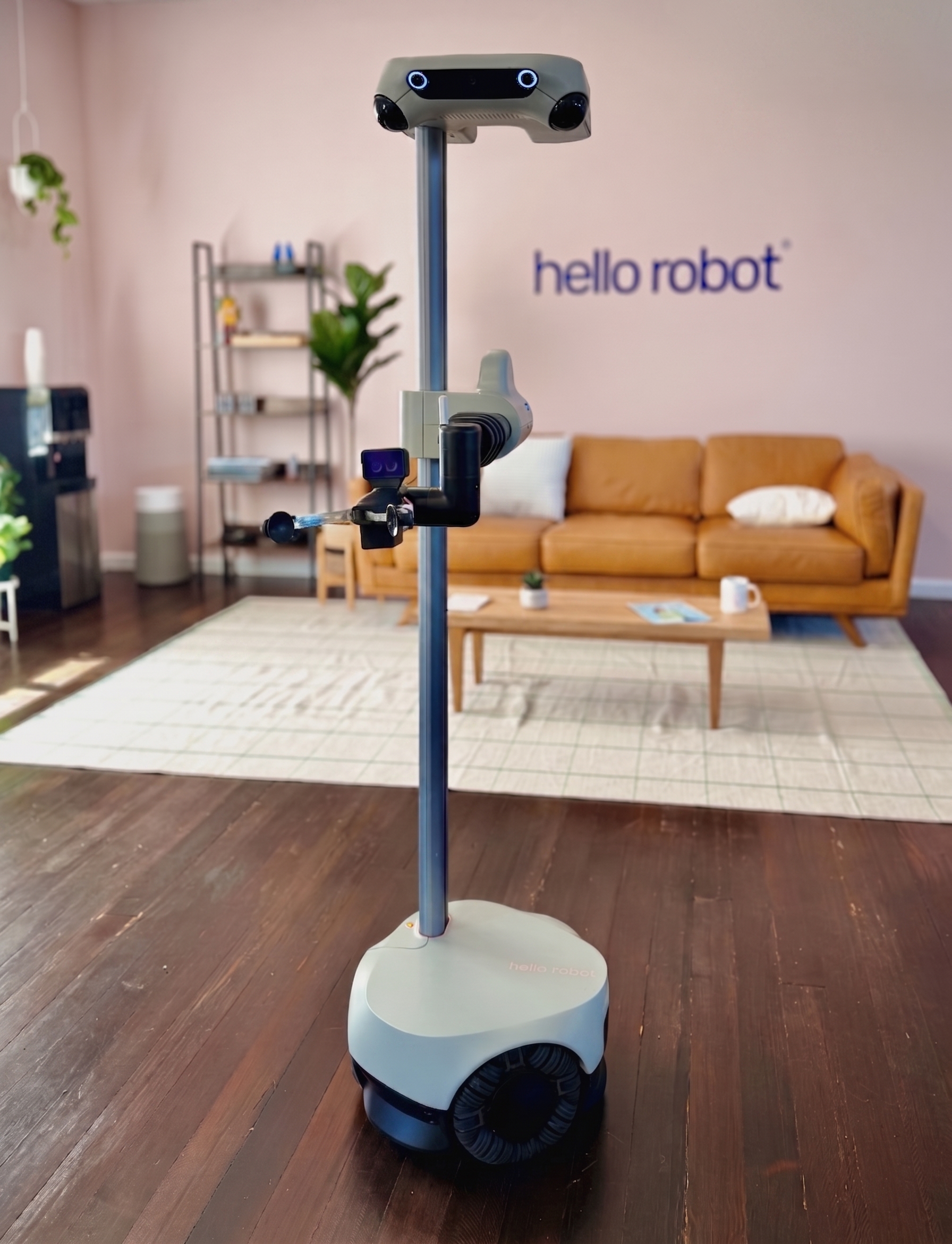 Stretch 4 robot standing in Hello Robot office living-room set