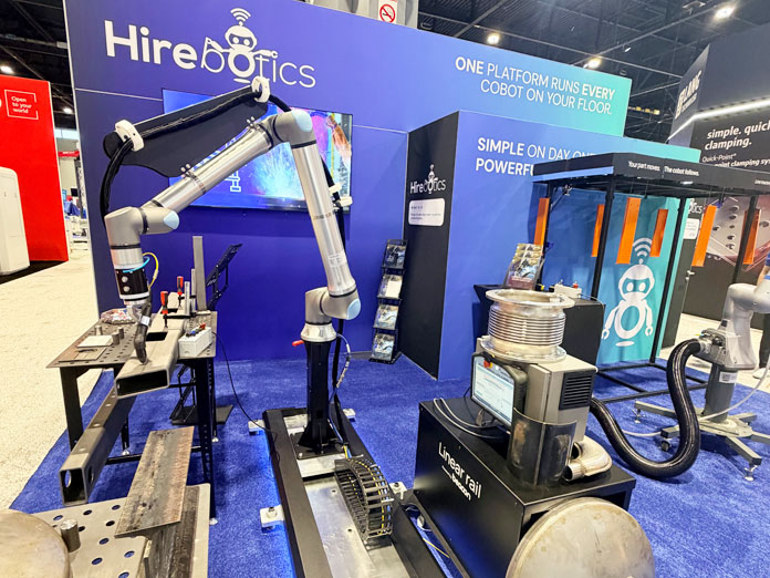 Hirebotics IMTS booth with a cobot welder mounted on a labeled linear rail