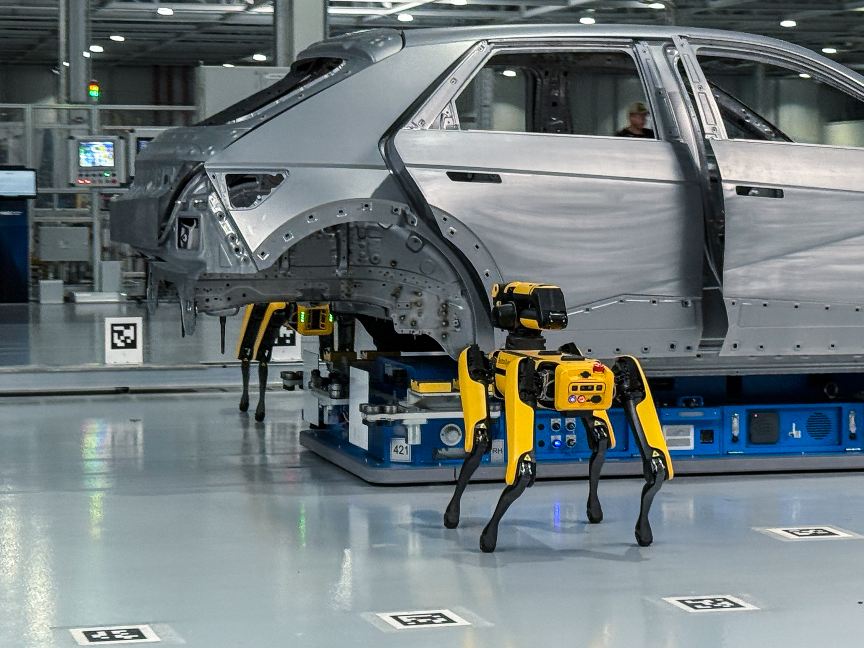 Boston Dynamics Spot robots inspecting a car body at Hyundai Metaplant America