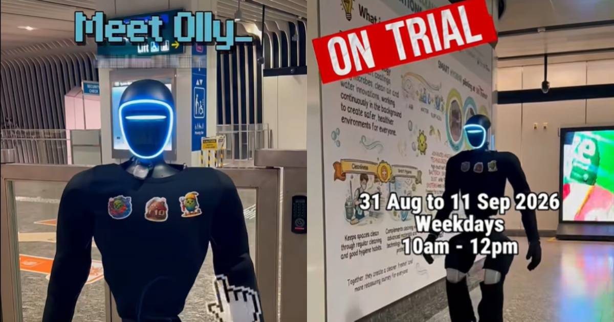 Olly, a black humanoid with a glowing face ring, standing at Little India MRT