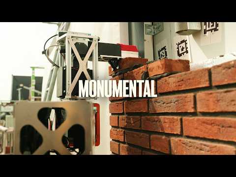 YouTube thumbnail of Monumental robot at a brick wall