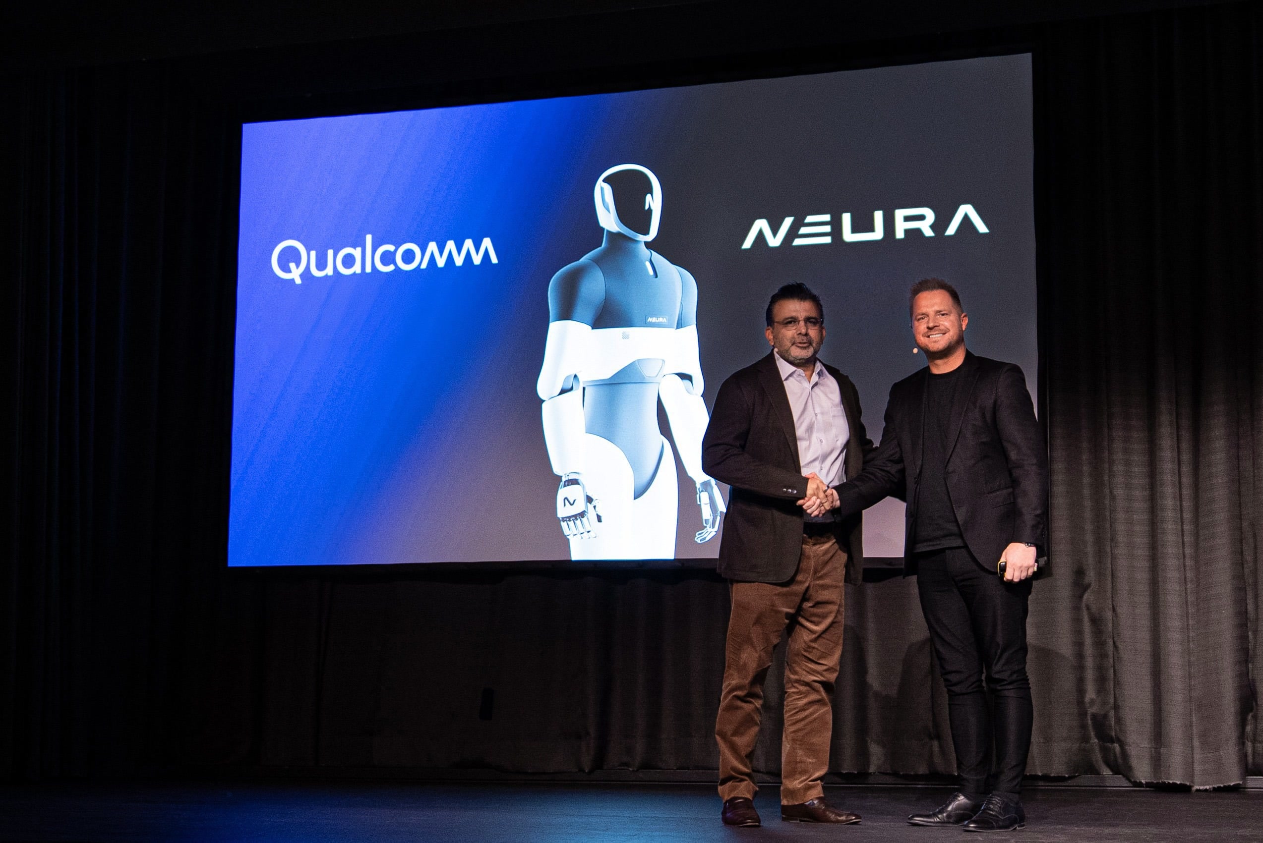 NEURA and Qualcomm executives on stage with 4NE1 imagery