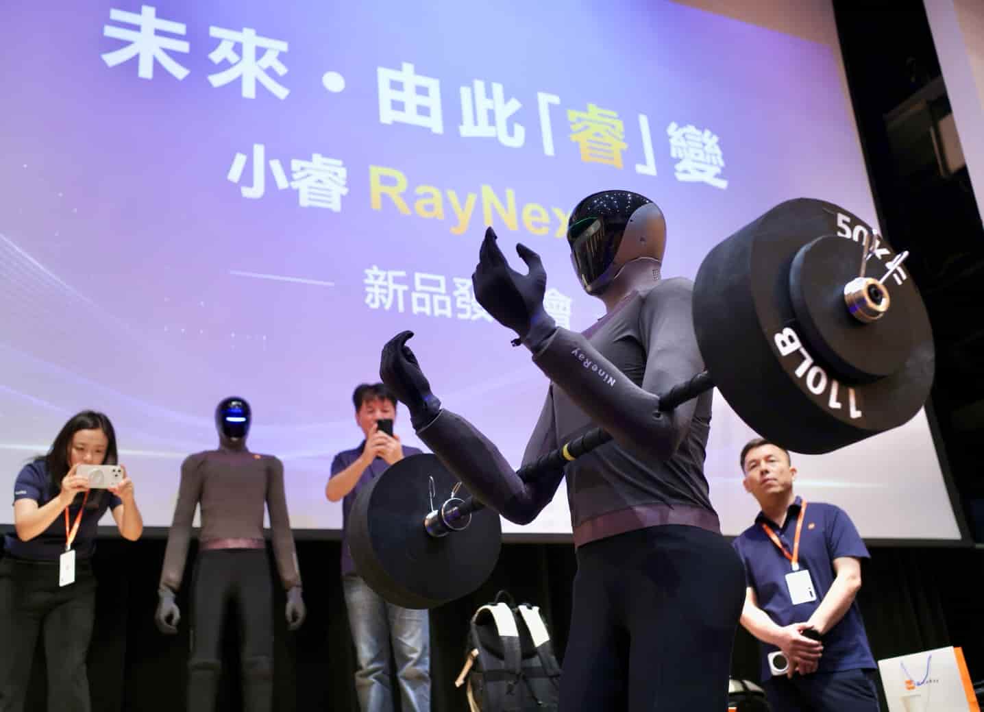 RayNex G3 humanoid holding a barbell on stage at Hong Kong Science Park