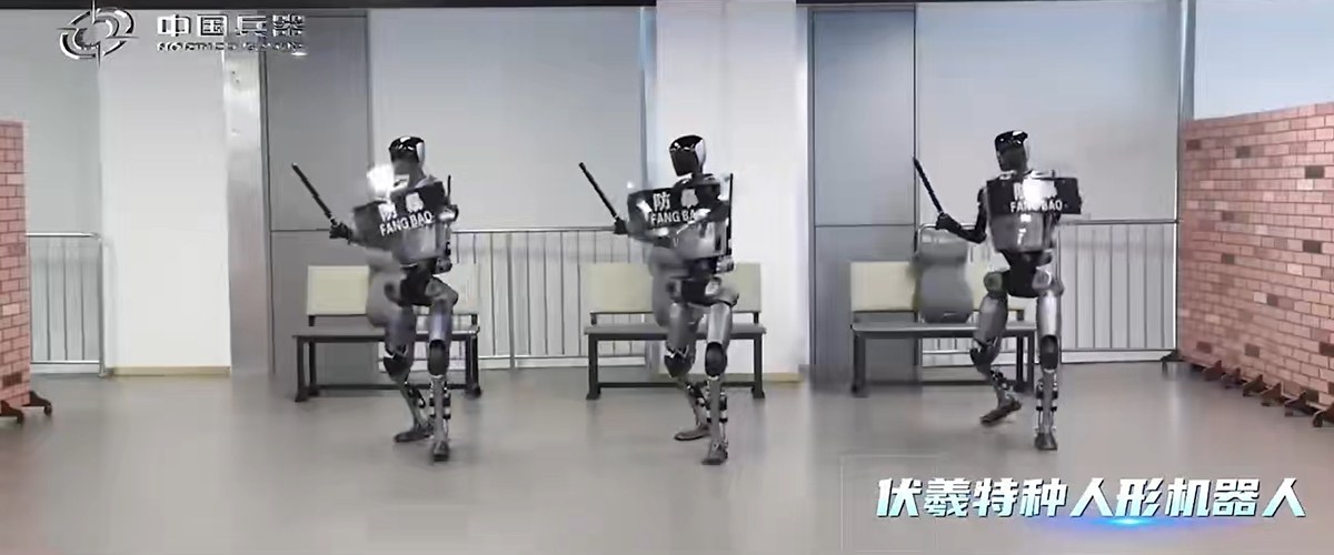Three Fuxi humanoid robots in formation with shields and batons