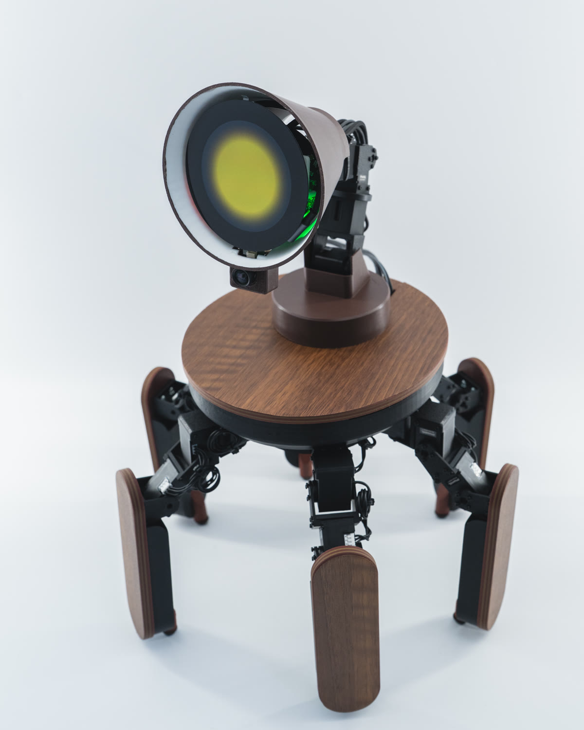 Palmimo DevKit on a white background, wood round table, six legs, round yellow face display