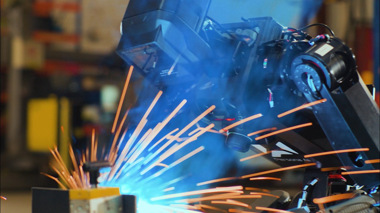 Close-up of a Persona AI humanoid torch throwing sparks on a workpiece