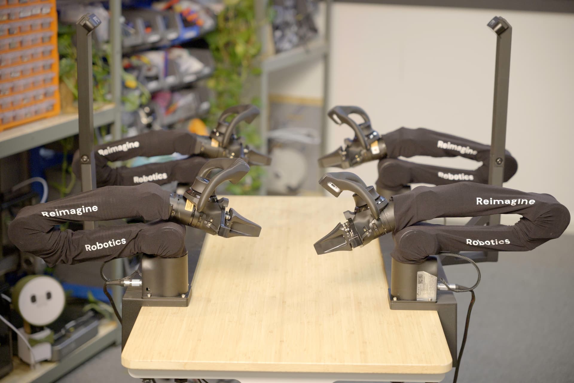 Four R2 robot arms arranged around a work table