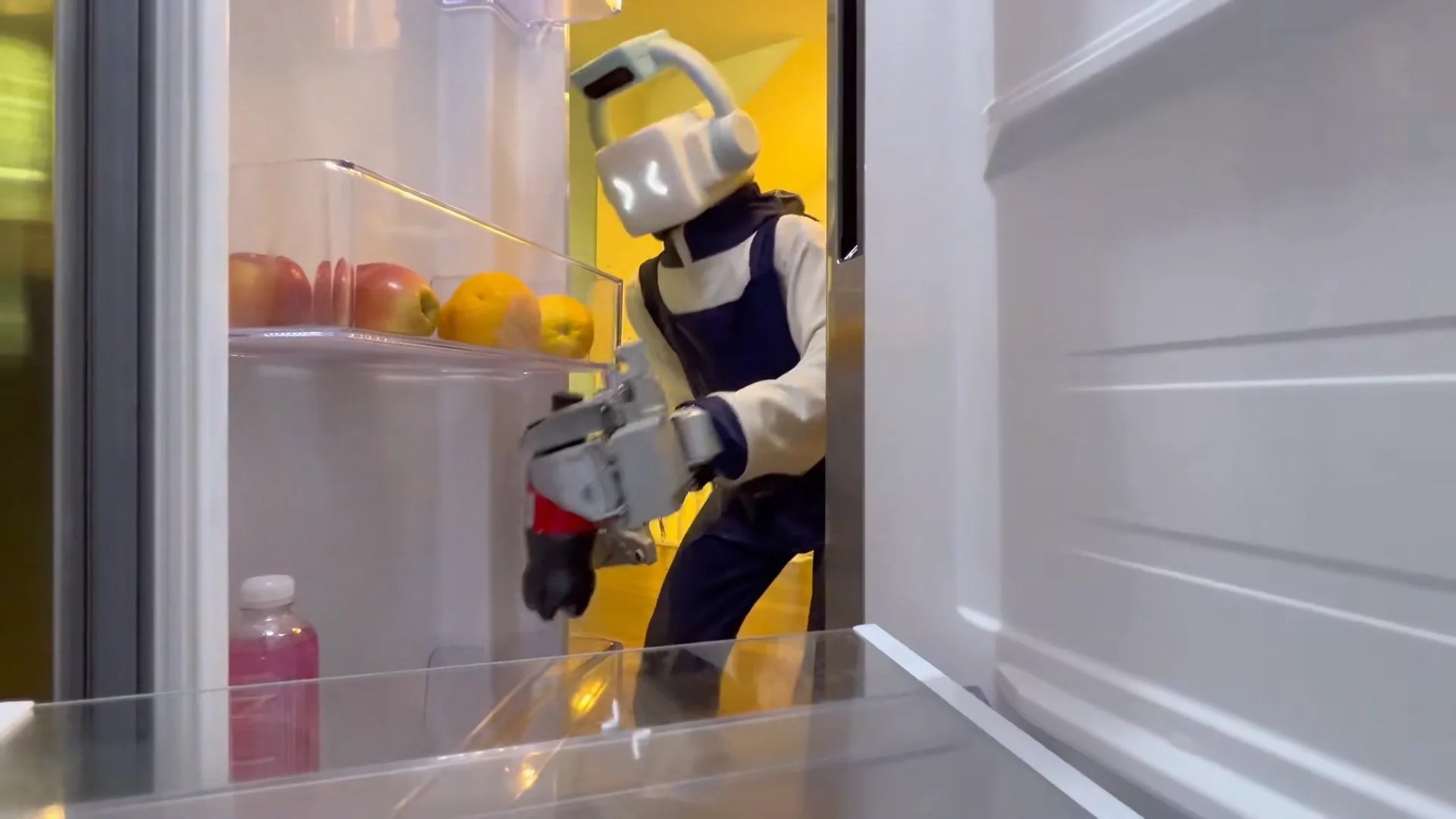 Humanoid reaching into an open refrigerator to grab a bottle from a door shelf