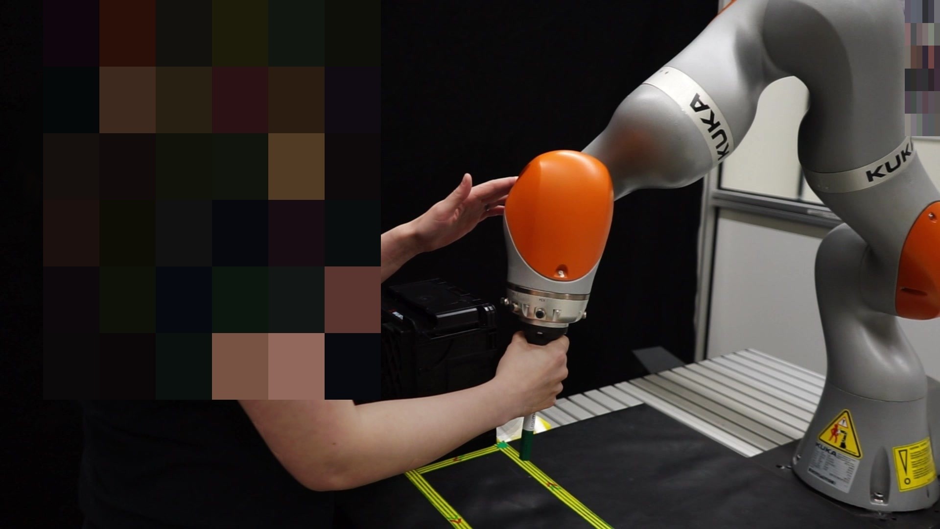 Operator guiding a KUKA LWR iiwa with a marker along a rectangular path
