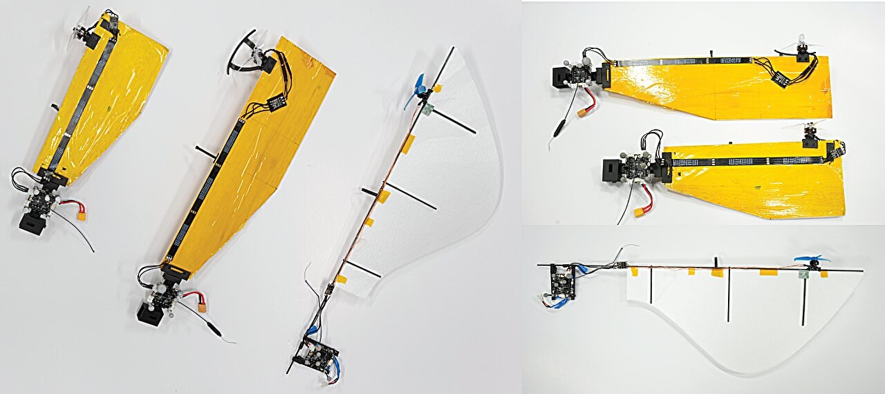 Three SAM wing variants: two yellow taped wood wings and a white foam wing with a blue propeller