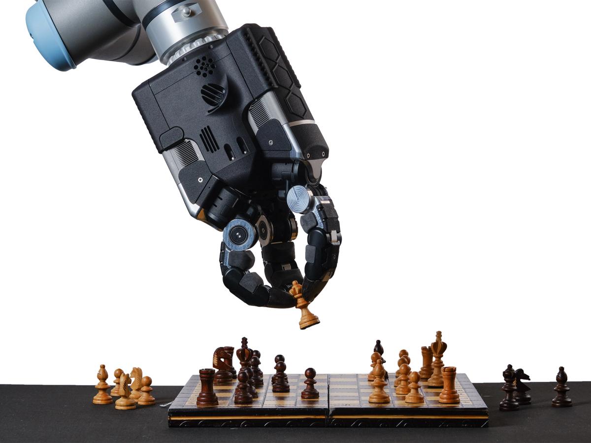 DEX-EE hand placing a chess piece