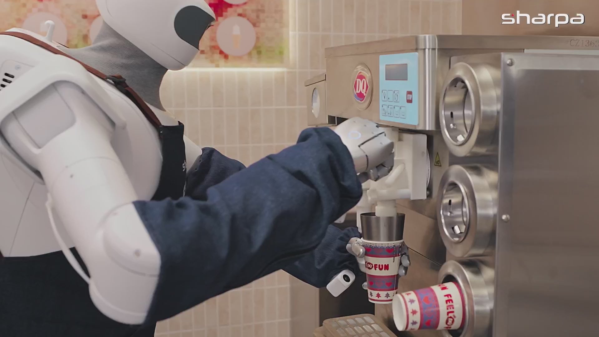 Sharpa North at a Dairy Queen blender, holding a paper cup under the mix head
