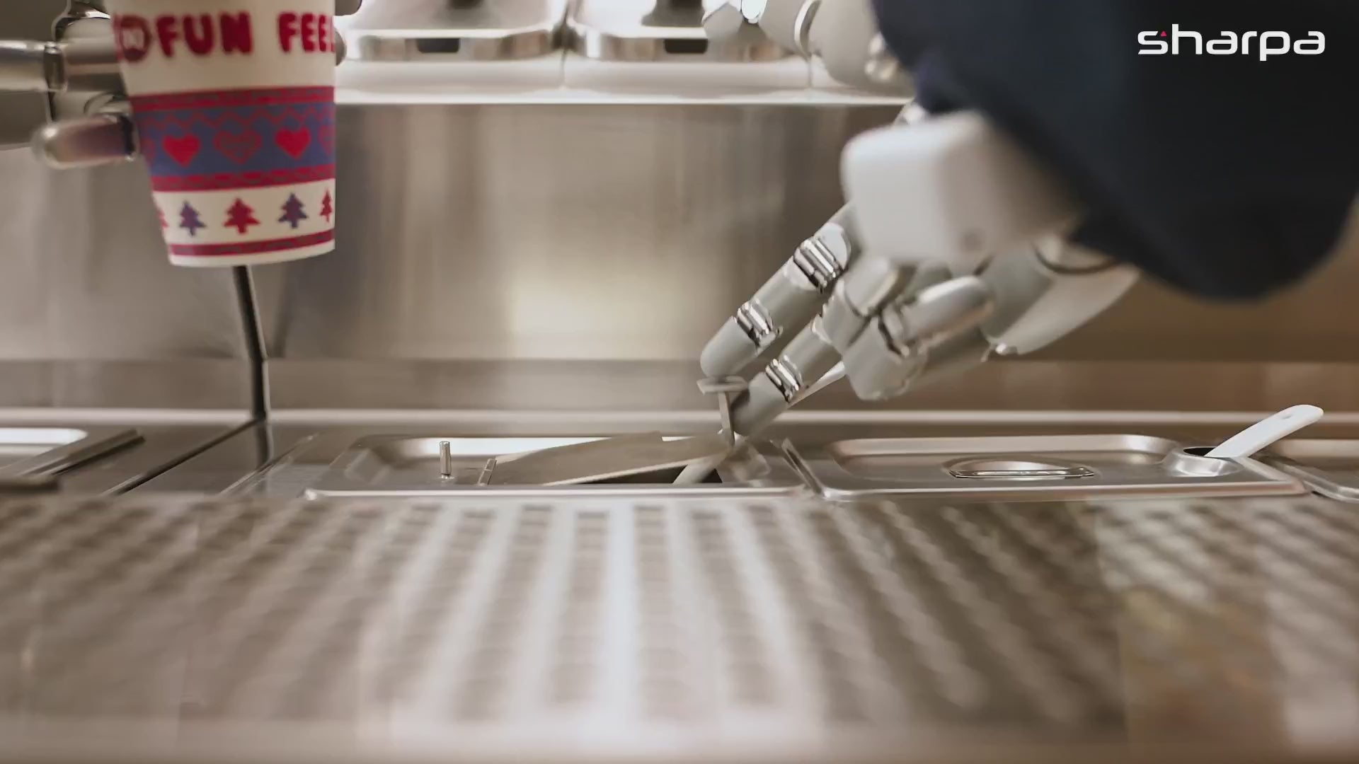 Sharpa North’s metal hand lifting a topping-bin lid at a Dairy Queen station