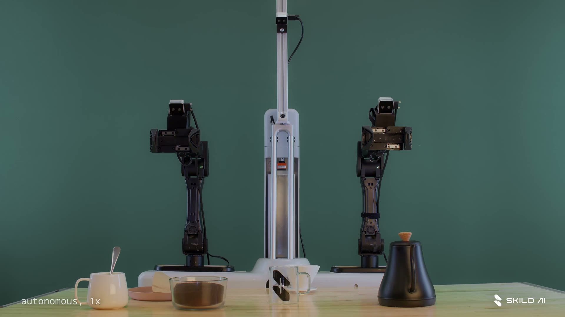 Dual robot arms at a pour-over coffee setup with kettle, mug, and grounds