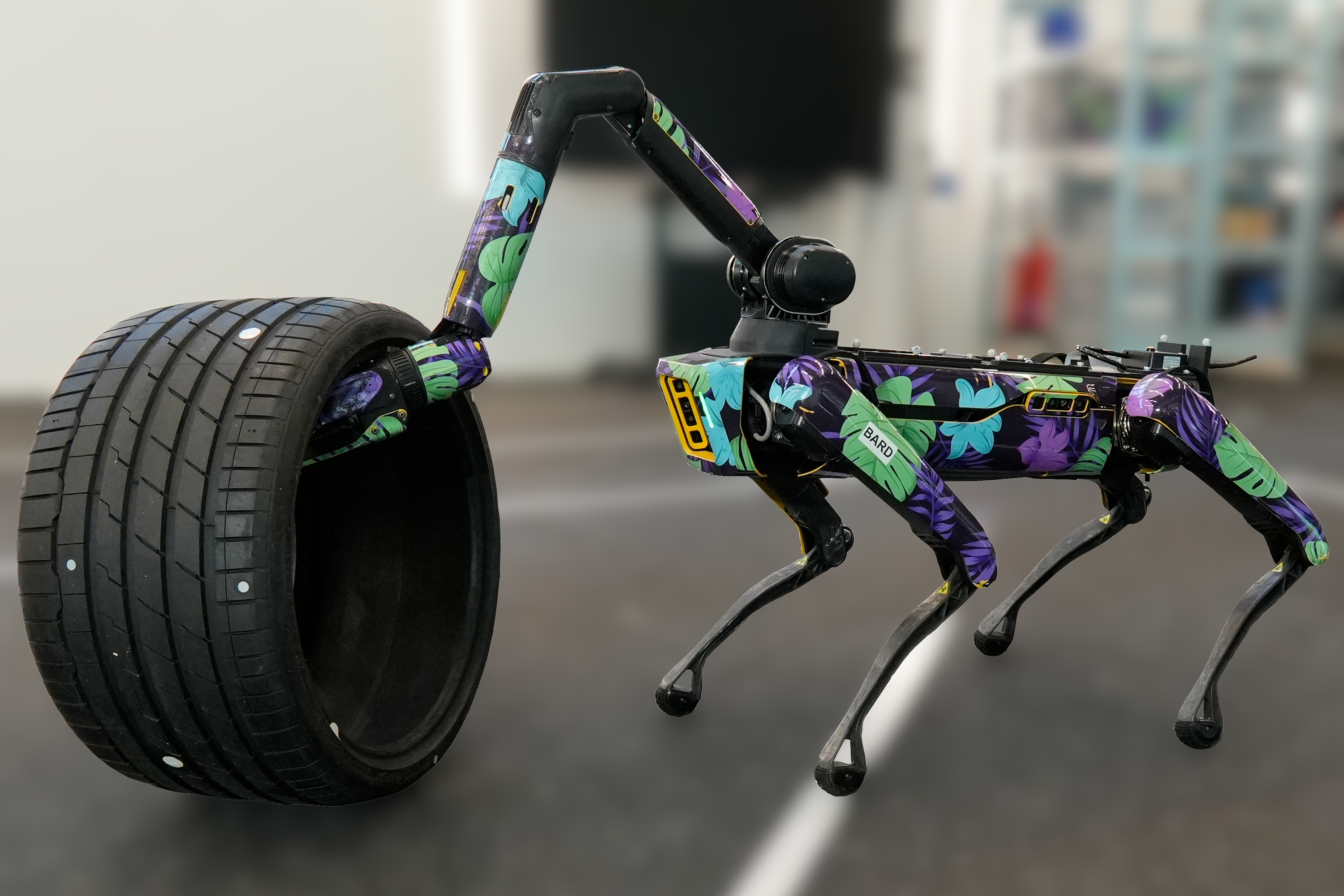 Arm-equipped Spot in floral wrap rolling a car tire
