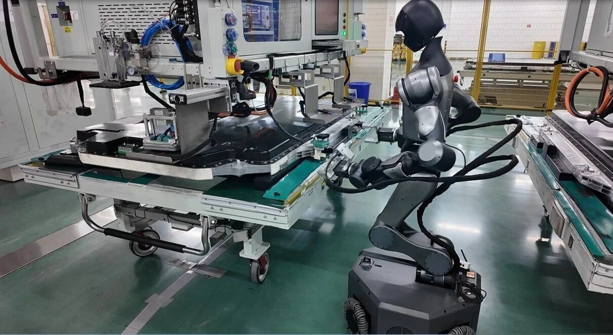 Wheeled Moz1 humanoid working beside a CATL battery production fixture