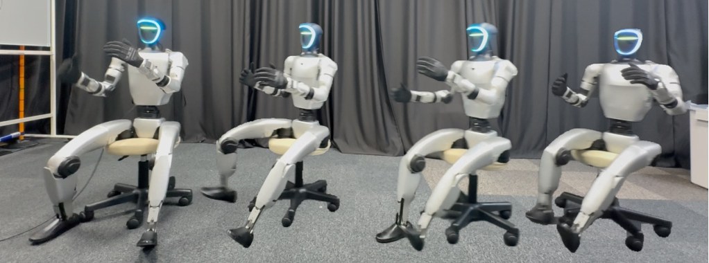 Four Unitree G1 humanoids seated on caster office chairs, legs extended in different directions