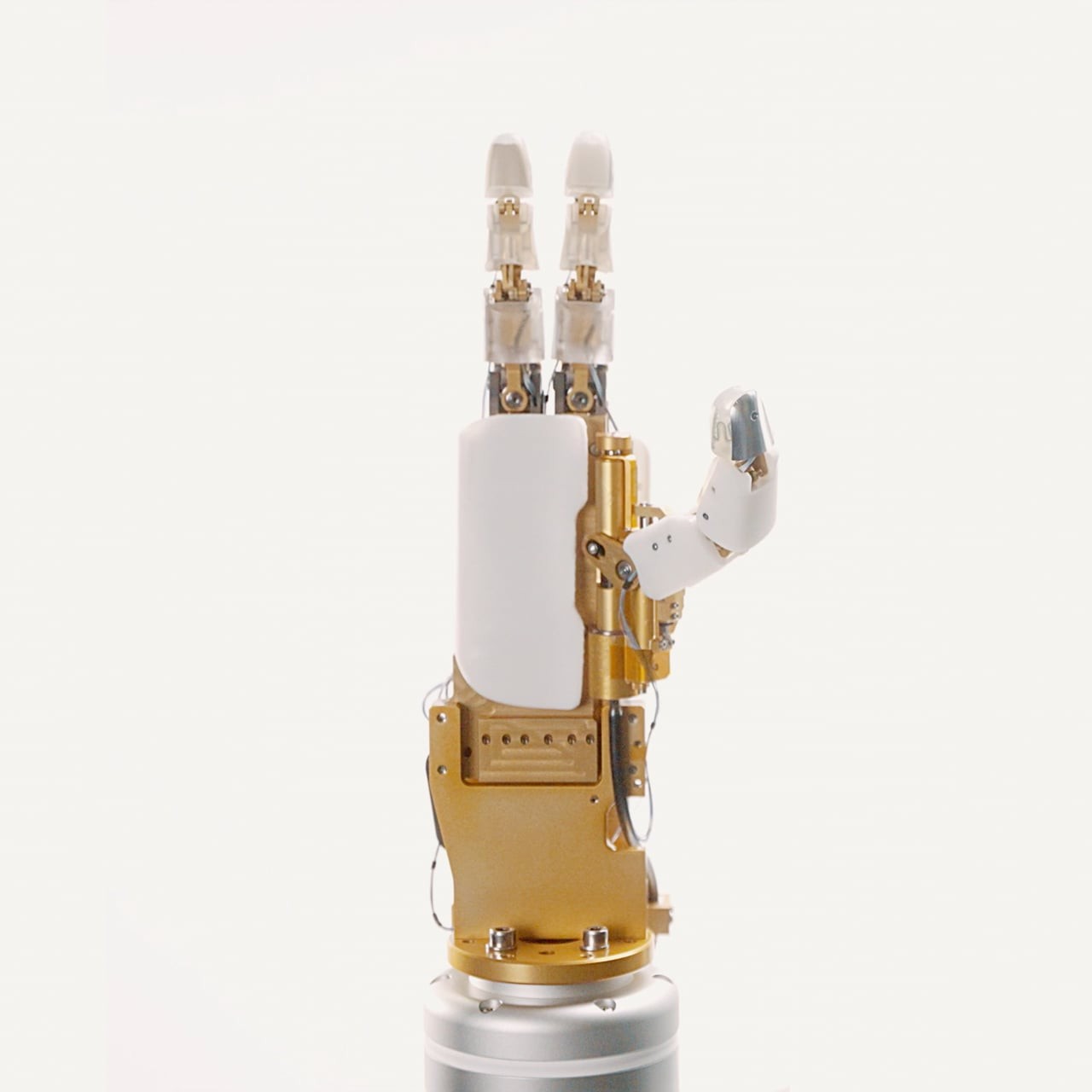 Tacta five-finger industrial robotic hand with brass structure and translucent fingertips