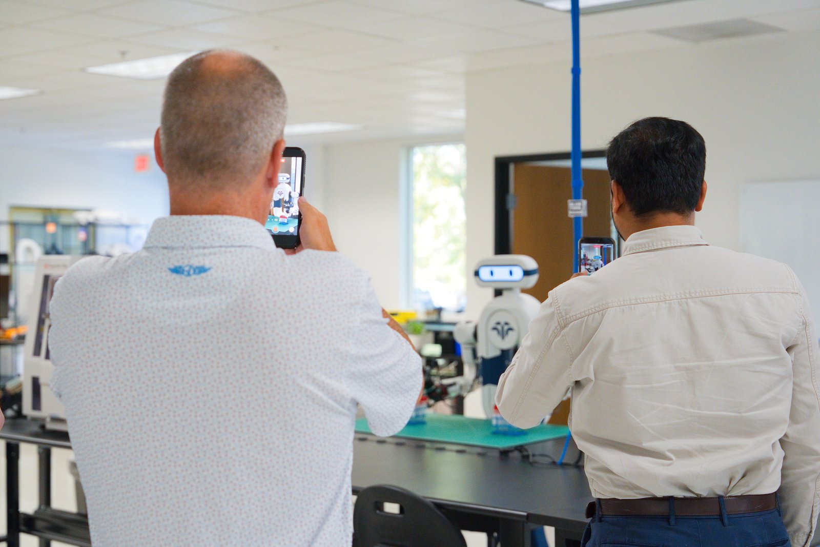 Guests photographing Elsie at the clinical lab bench during open house