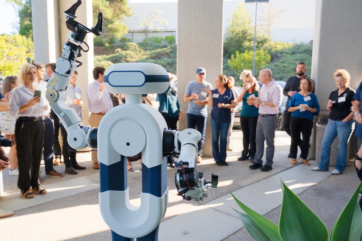 Elsie humanoid lab assistant raising an arm at Tactus AI open house