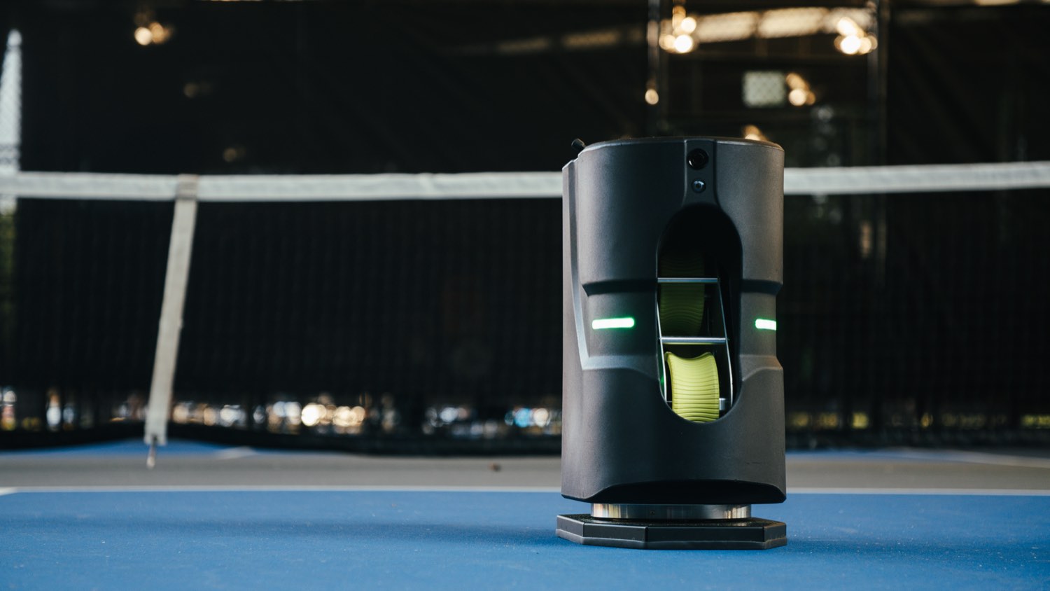 Stationary Tennibot Partner Lite on a padel court, no drive base, green LEDs on