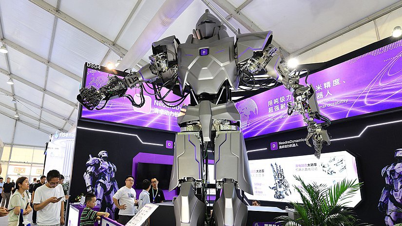 Four-meter-class humanoid on a WRC 2026 booth with hydraulic-looking arms