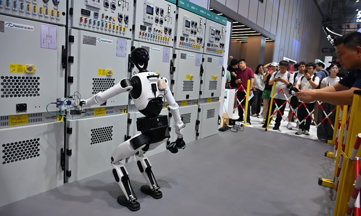 Tien Kung 3.0 humanoid reaching a test probe toward high-voltage cabinets at WRC 2026
