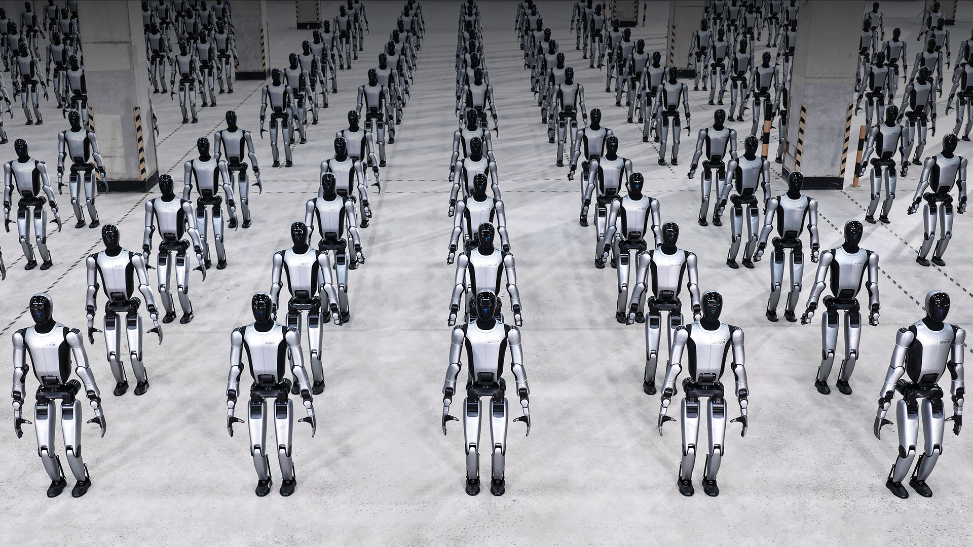 Rows of silver-and-black UBTECH Walker S2 industrial humanoids standing in a factory hall