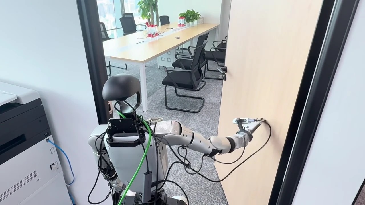 G1 humanoid reaching for a door handle in an office hallway