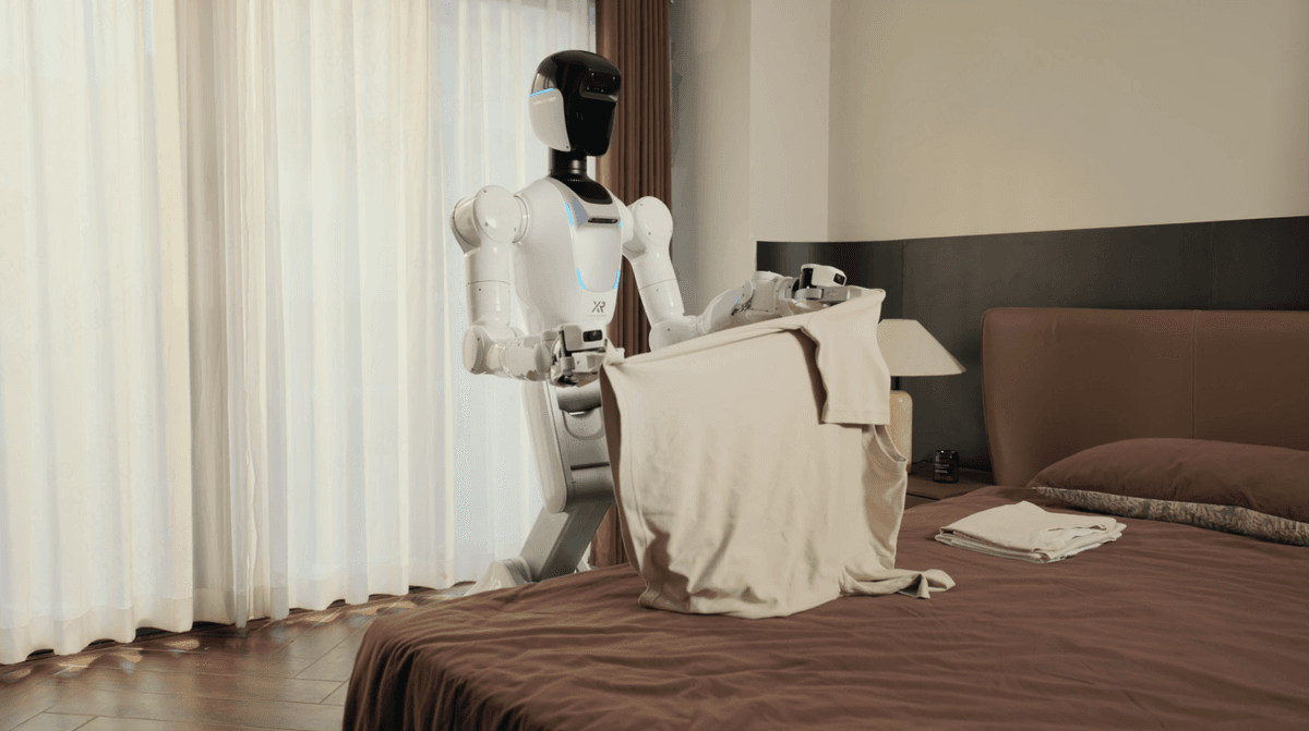X Square Robot humanoid folding laundry on a bed