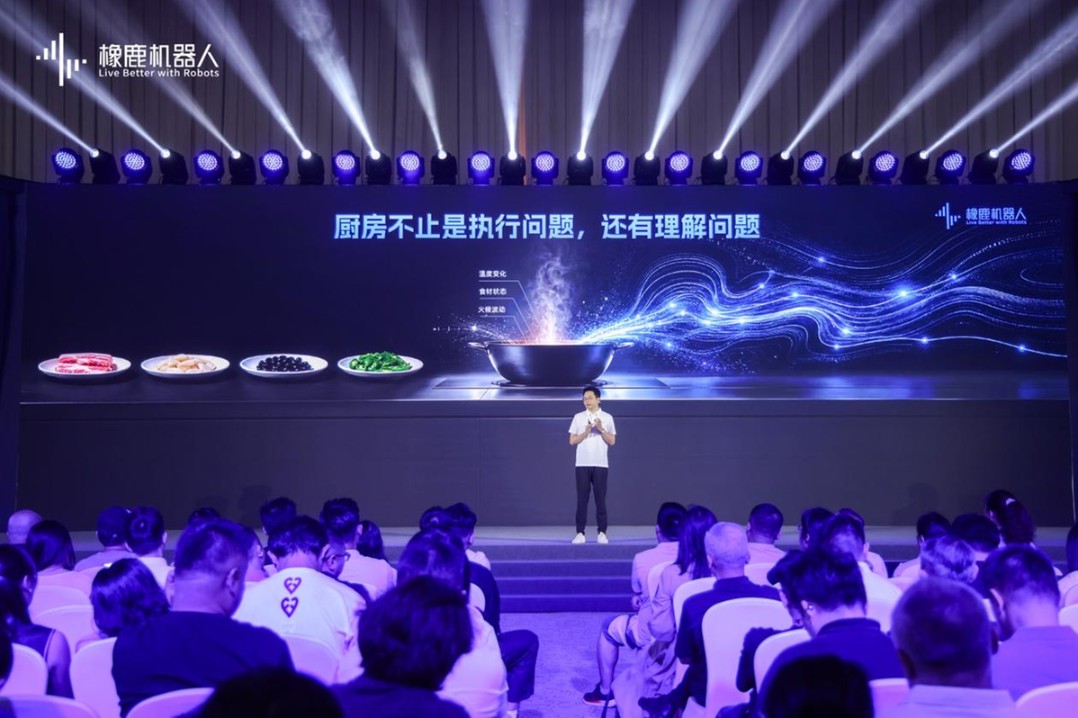 Xianglu founder on stage at WRC in front of a wok graphic and plates of ingredients