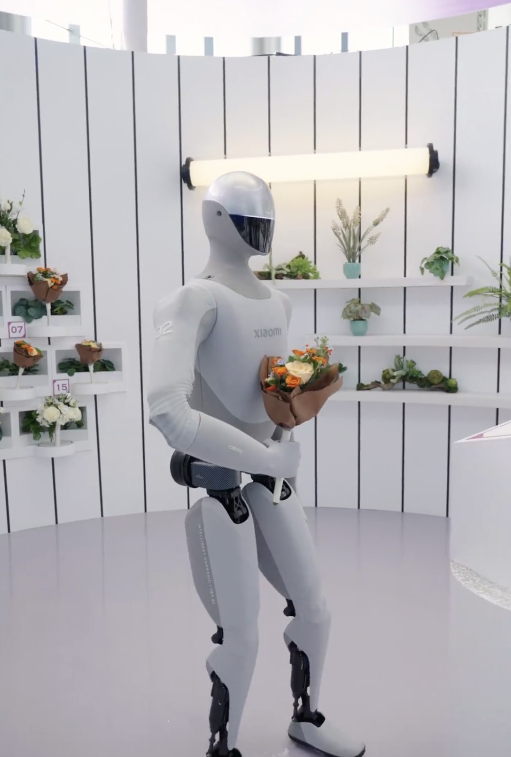 Xiaomi CyberOne holding a bouquet in a florist booth at WRC 2026
