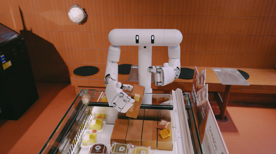 DEUX semi-humanoid robot picking up an item at LoungeX store
